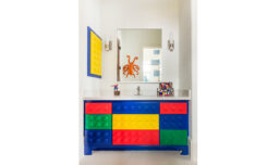 Bright and playful, this Lego-themed bathroom vanity features colorful blocks and a mirror reflecting octopus decor.