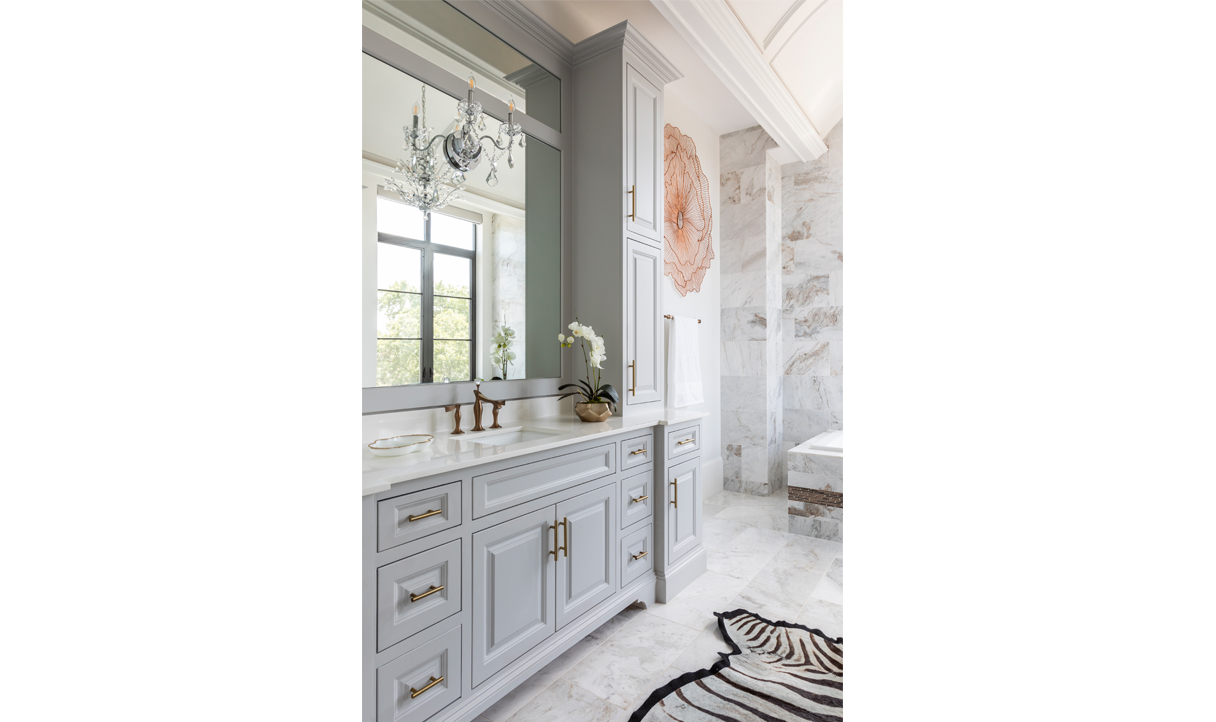 Elegantly designed bathroom adorned with a chic zebra print rug, luxurious marble walls, and abundant storage solutions for a sophisticated and organized bathing space.
