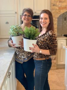 Decorators Danna Smith and Pamela O'Brien holding herbs at photoshoot