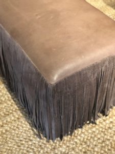 brown ottoman with fringe for a living room