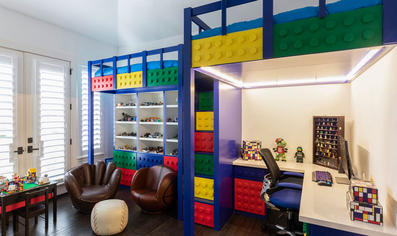 A vibrant youth bedroom with a Lego-themed twist! Featuring loft beds made of Legos, a Lego-sided desk, and sporty seating arrangements.