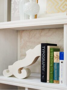 Use statement bookends to display books on shelves