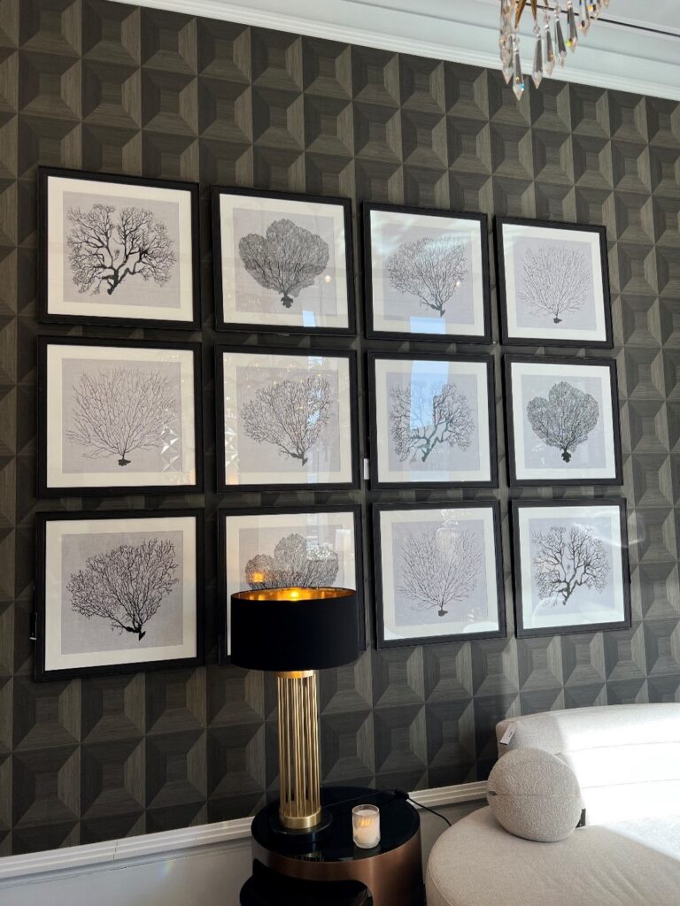 Wall of black and white coral prints at Eichholtz